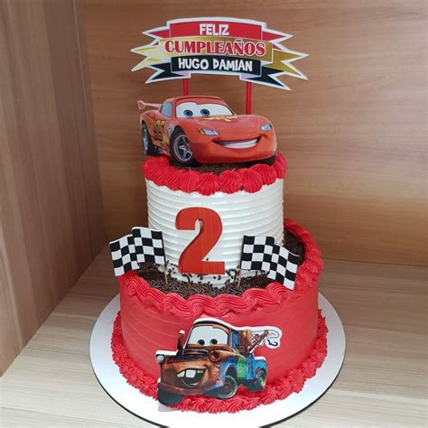 Two Tiered Cake With Cars On Top And The Number In Front Of It