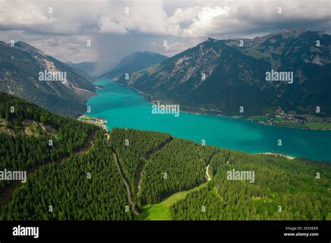 An Aerial View Of Achen Lake Between Lush Green Steep Mountains In