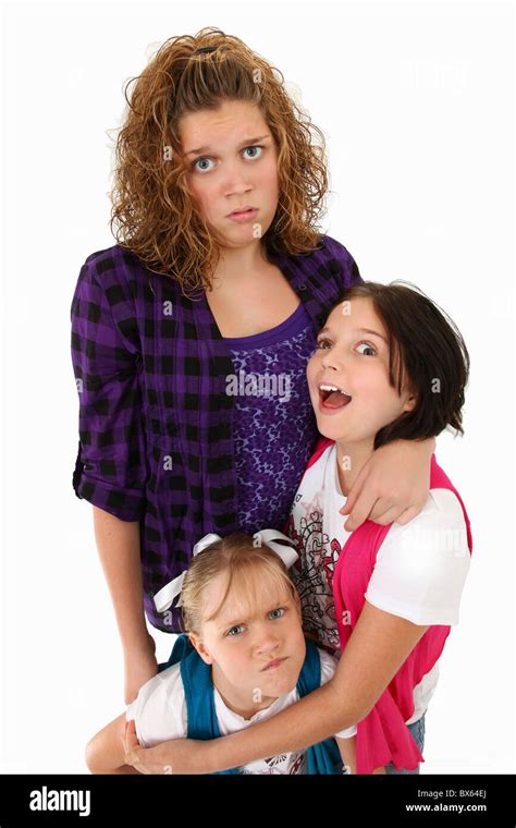 Adorable American Sisters Making Silly Faces Over White Background