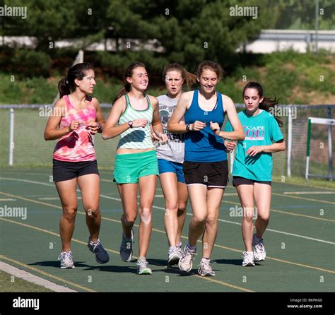 Five High School Teenage Girls Track Team Runners Running Around The