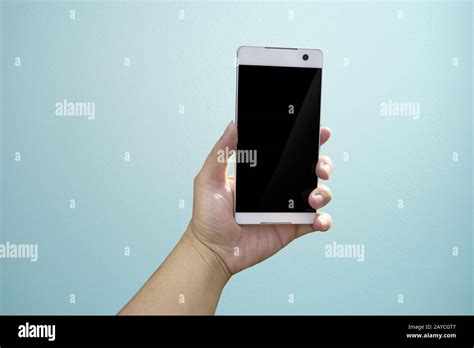 Hand Holding Mobile Smart Phone With Blank Screen Isolated On Light