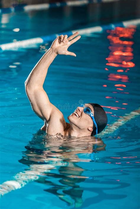 Portrait Of Handsome Muscular Swimmer In Swimming Cap And Goggles