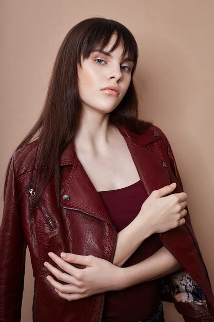 Premium Photo Sexy Brunette In Leather Jacket And Red Top