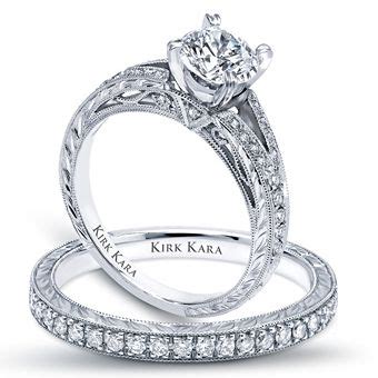 Two Wedding Rings With Diamond Accents On Each Side And The Words Kirk