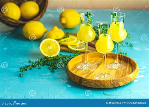 Limoncello With Thyme In Three Grappas Wineglass In Wooden Tray Fresh