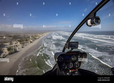 Aerial View Through The Windscreen Of A Helicopter Over The Coast And Beach At Walker Bay Nature