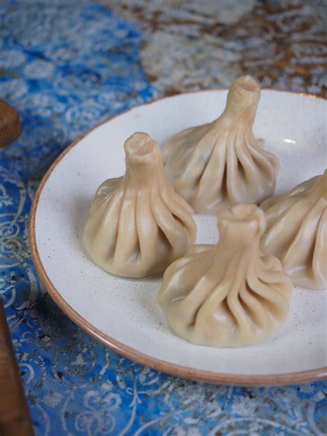 Woman Holding Dumplings with Chopsticks · Free Stock Photo