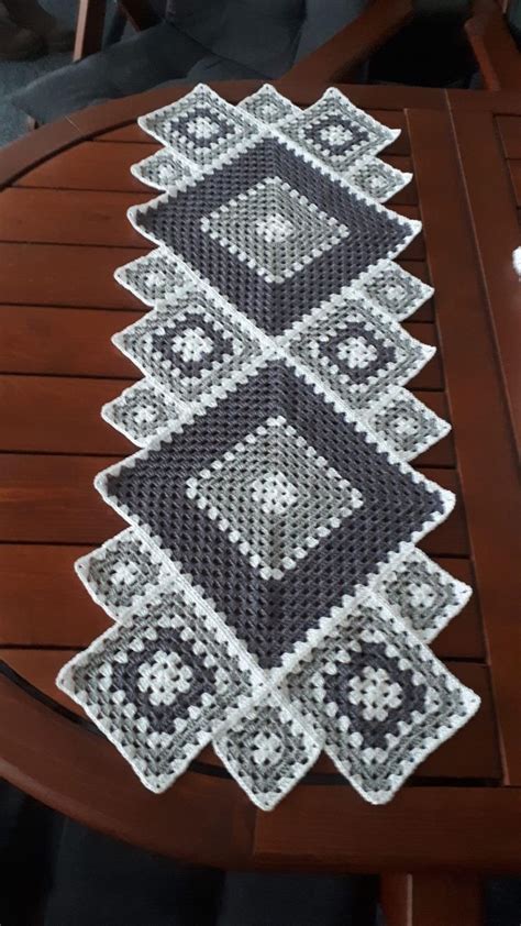 A Wooden Table With A Crocheted Design On It S Top And Bottom