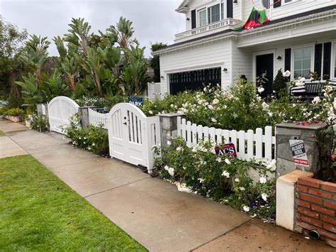 White arched solid driveway gates and fence