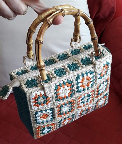 A Person Holding A Handbag Made Out Of Crochet