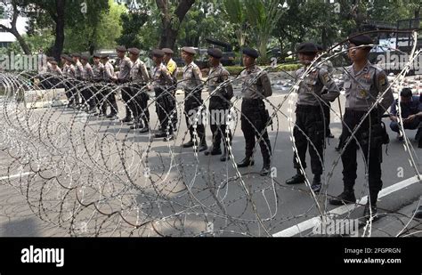 Uniformed Police Officers Behind Barbed Wire Security Blockade Jakarta