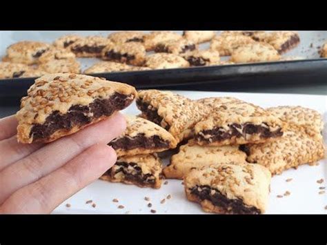 Someone Is Holding Up Some Cookies On A Plate