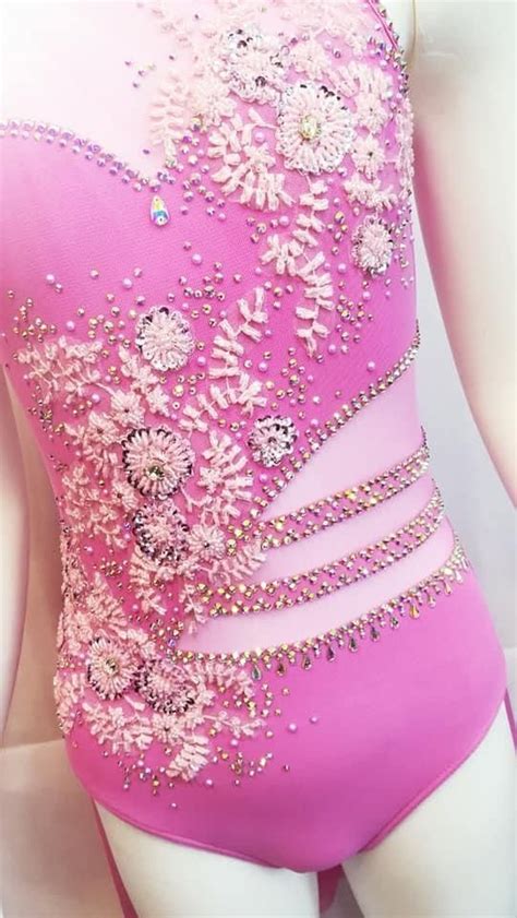 A Woman S Pink Leotard With Flowers On The Side And Beading