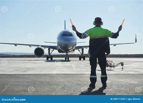 The Runway Traffic Controller Uses Gestures And Sticks To Help The Aircraft Choose The Correct