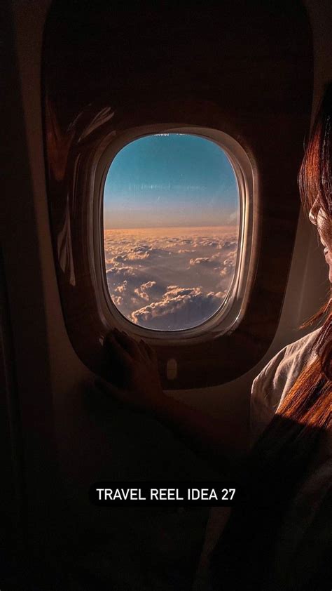 A Woman Looking Out An Airplane Window At The Clouds