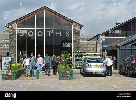 Shoppers outside Booths supermarket, Windermere town, Lake District ...