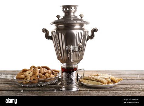 Vintage Samovar Cup Of Hot Drink And Snacks On Wooden Table Against