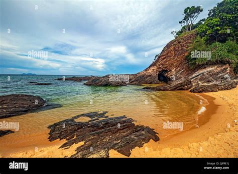 Golden Sand Beach With Rocky Outcrops At Pantai Teluk Bidara Beach In