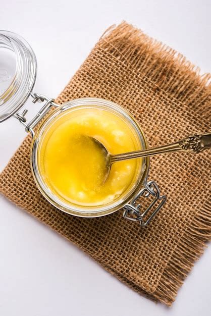 Premium Photo Ghee Or Clarified Butter Close Up In Wooden Bowl And