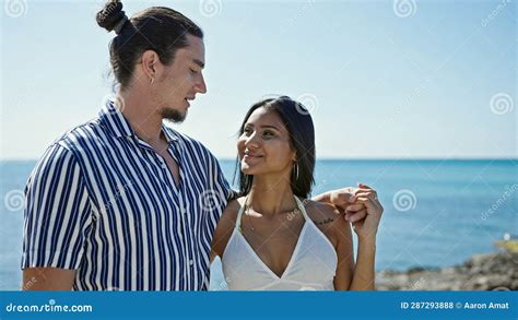 Man And Woman Couple Smiling Confident Hugging Each Other At Seaside