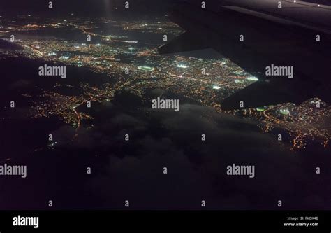 Aerial View Of Illuminated City Seen Through Airplane At Night