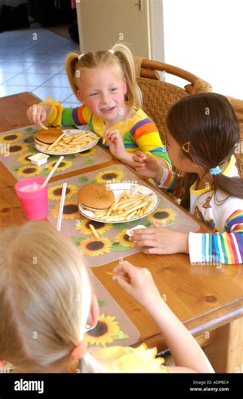 Three Girls Eating Hamburger Stock Photo Alamy