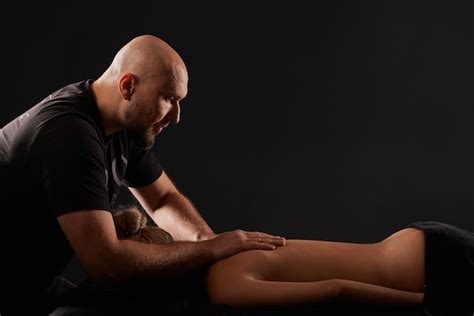 Premium Photo Handsome Male Masseur Giving Massage To Girl On Black