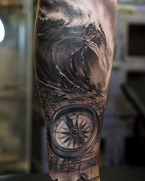 A Mans Leg With A Compass And Wave Tattoo On It