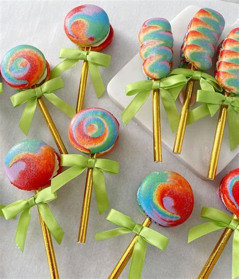 Colorful Lollipops With Green Bows And Ribbons On A White Tablecloth