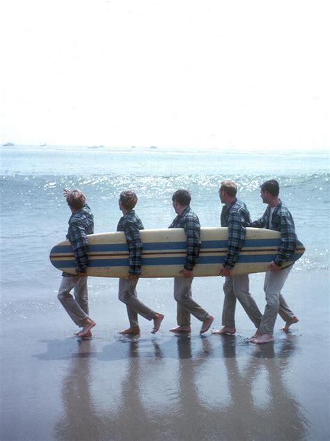 Beach Boys On The Beach With A Surfboard by Michael Ochs Archives