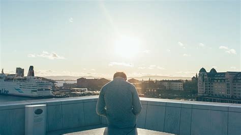 Man Wearing Quilted Gray Jacket Sitting Building Top Across Body Pxfuel