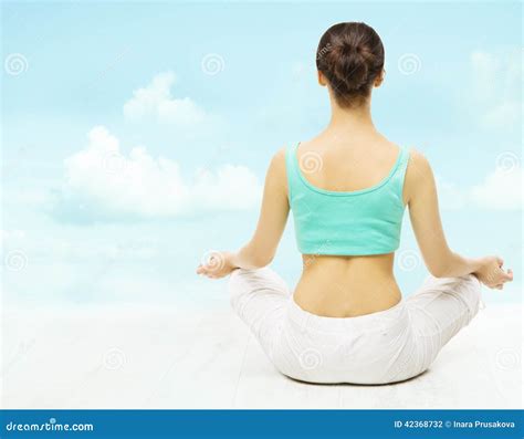 Yoga Woman Back View Meditate Sitting In Lotus Pose Over Sky Background