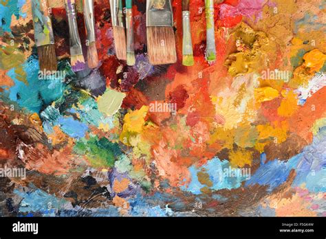 Artist's paintbrushes on palette with various oil colors Stock Photo ...