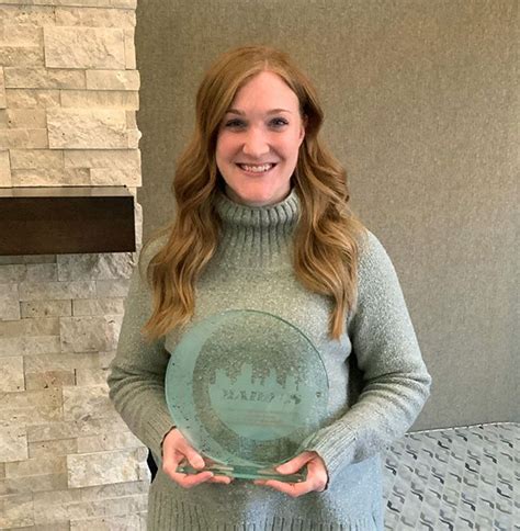 Alyssa Nimmo Stands Holding Her 2020 Madacs Award For Community Manager