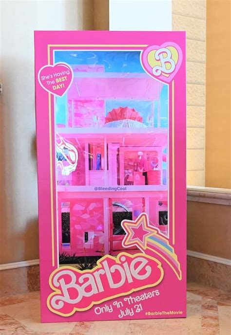 a pink barbie doll house with its doors open