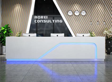 The Front Desk Of An Office Building With Clocks On The Wall And Plants