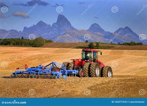 Tractor Farming Ground Harvesting Crops In Fall Autumn Teton Mountains