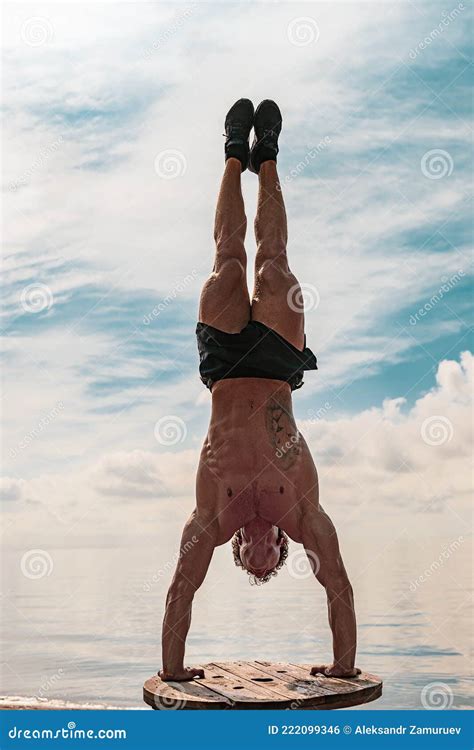 Young Man Is Doing Street Workout Handstand Exercise Bodyweight Stock