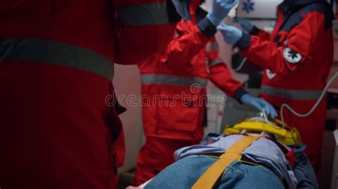 Professional Paramedics Performing First Aid Procedure In Emergency Car