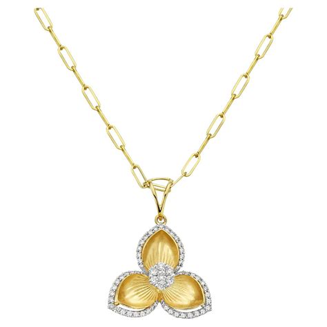 Flower Shaped Pendant With Carved Petals Equipped With Halo Diamonds In