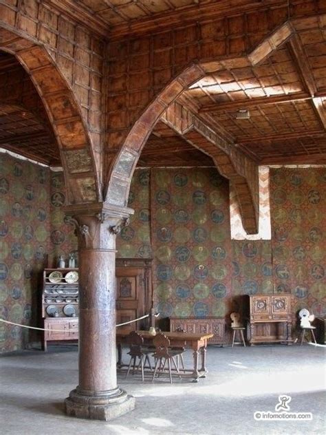 An Ornate Room With Wooden Columns And Wallpaper