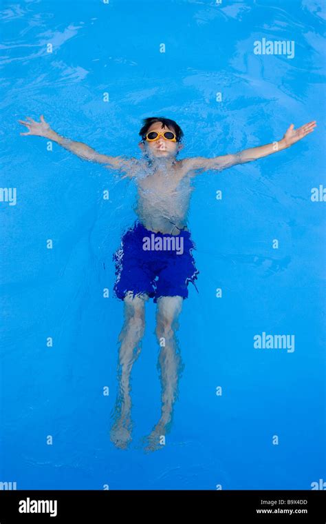 9 year old boy swimming in pool Stock Photo - Alamy