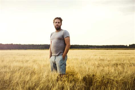 Man Standing In Grain Field Stock Photo