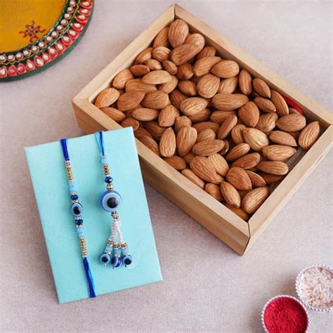 Send Bhaiya Bhabhi Evil Eye Rakhi With Almonds In Tray Online