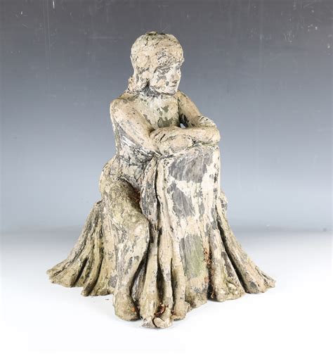 A Sculpted Composition Figure Of A Nude Female Sitting Astride A Chair