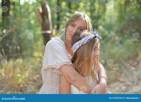 Mom And Daughter Hugged On The Beach Stock Image