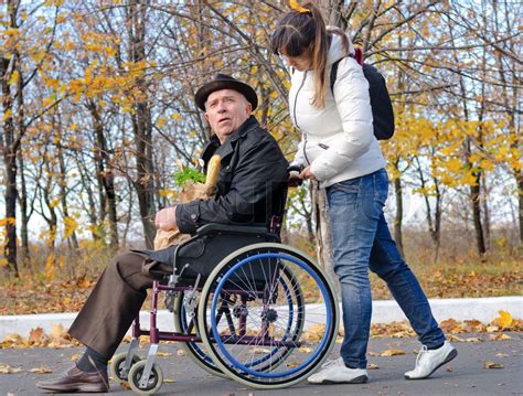 Woman Pushing An Elderly Man In A Wheelchair Stock Image Colourbox