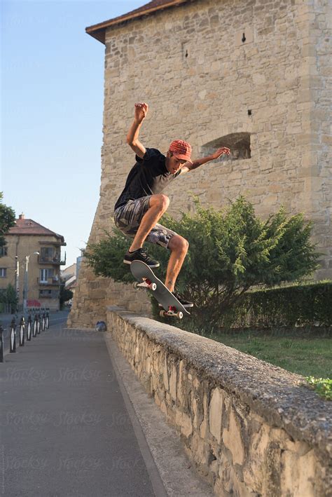 "Male Teenager Doing Midair Stunts With Skateboard In The City" by ...