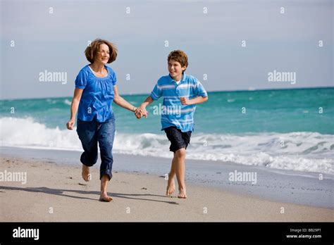 Mature Woman Running On Beach High Resolution Stock Photography And