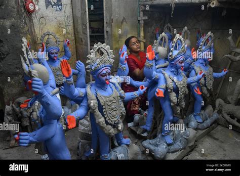 A Lady Is Seen Giving Final Touches To An Idol Of Kali Ahead Of Kali